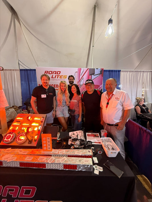 RoadLites team members and Alex the Mutha Trucker in the RoadLites Booth at Iowa 80's Trucker's Jamboree