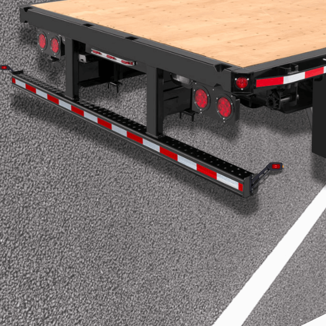 Flatbed trailer on a road with red contour marker lights installed on bumper.