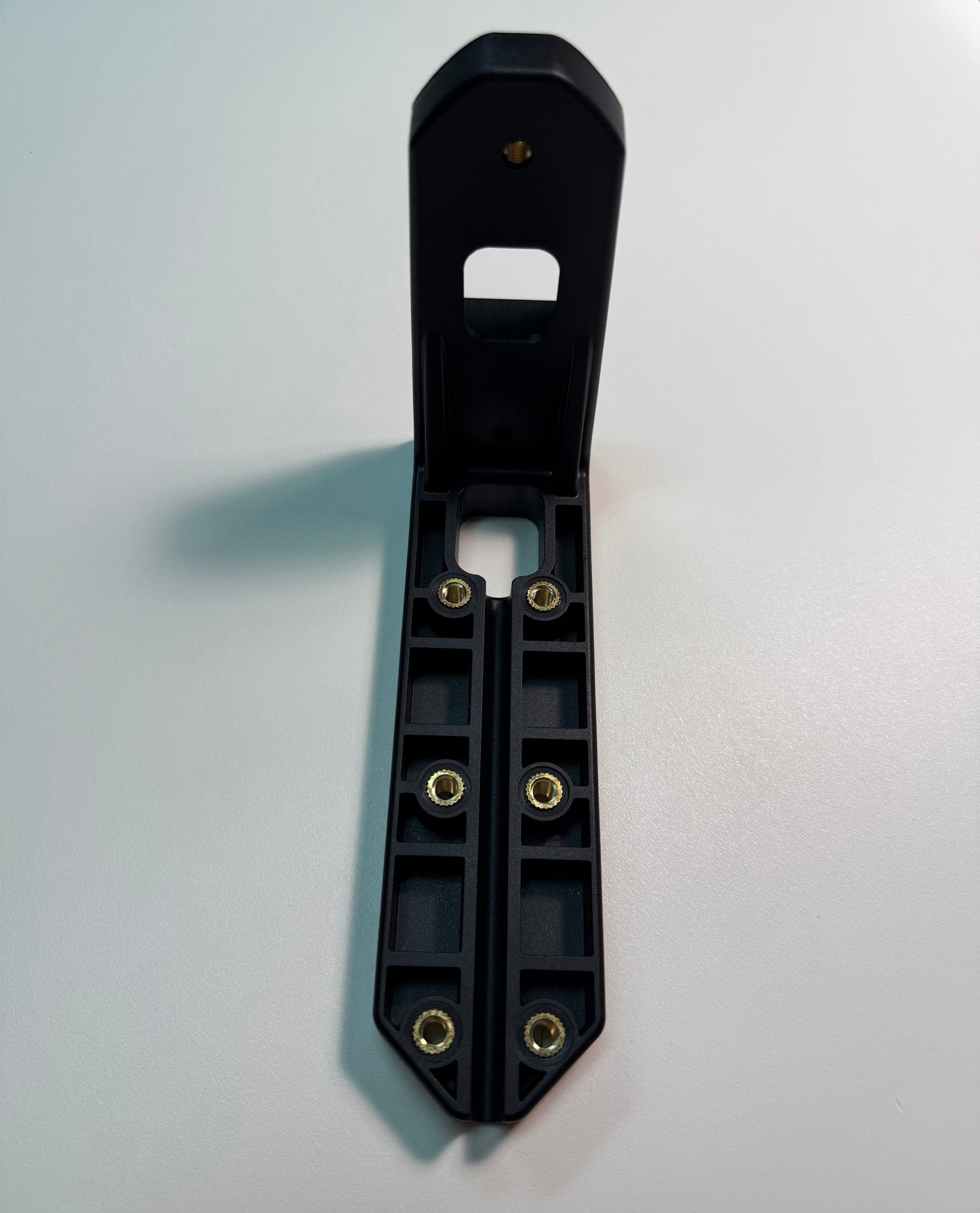 Top Bumper Mounting Bracket For Outline Marker Lights in black durable plastic with metal inserts on white surface