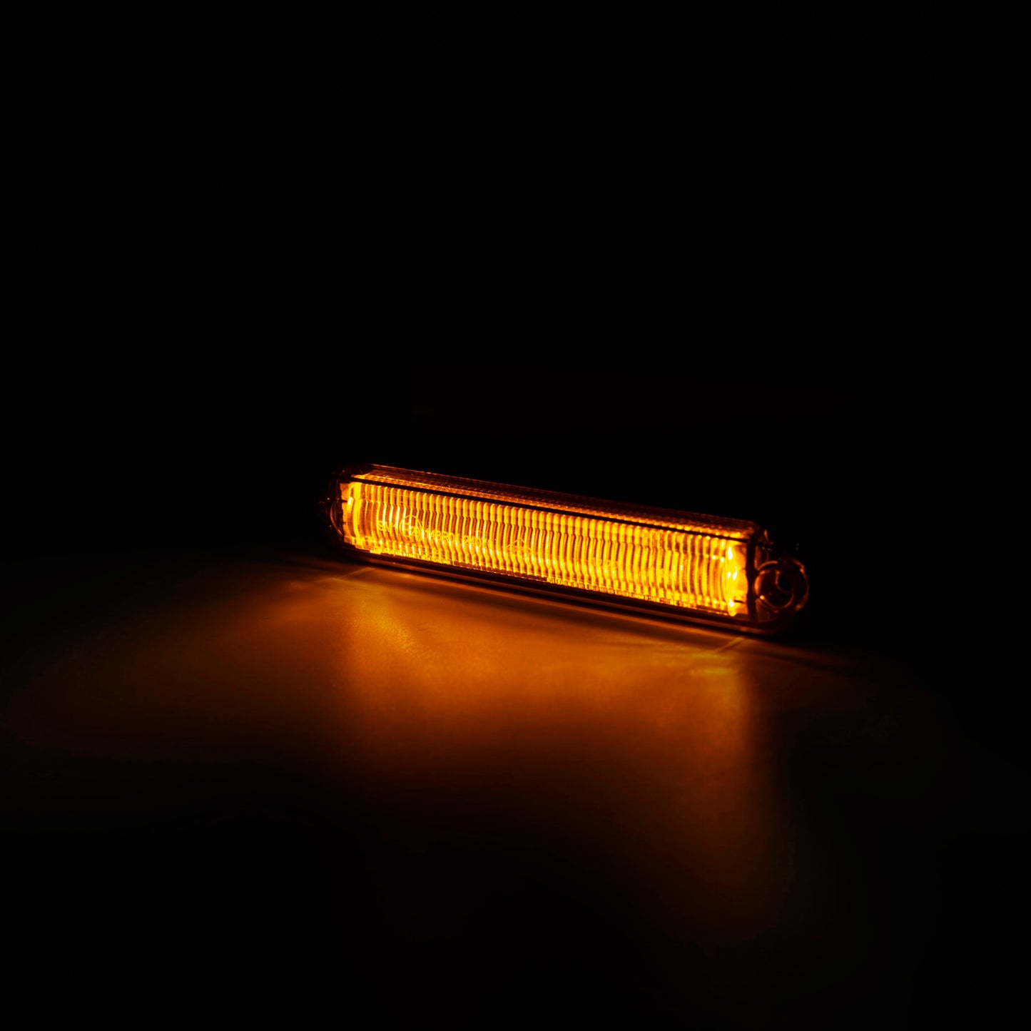 Amber LED Side Marker Light, Light Tube Slim Type LD 2333 glowing in dark, showing slim, durable design and bright amber illumination.