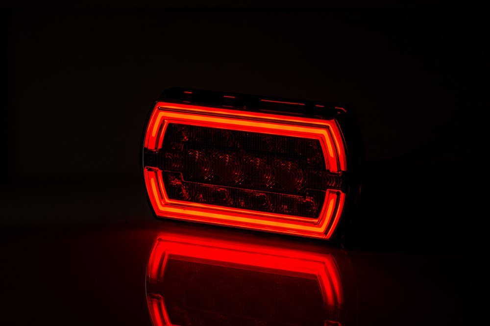 Multifunction Rear LED Light Cleo LZD 2790 glowing red with NEON-style position light in a dark setting.
