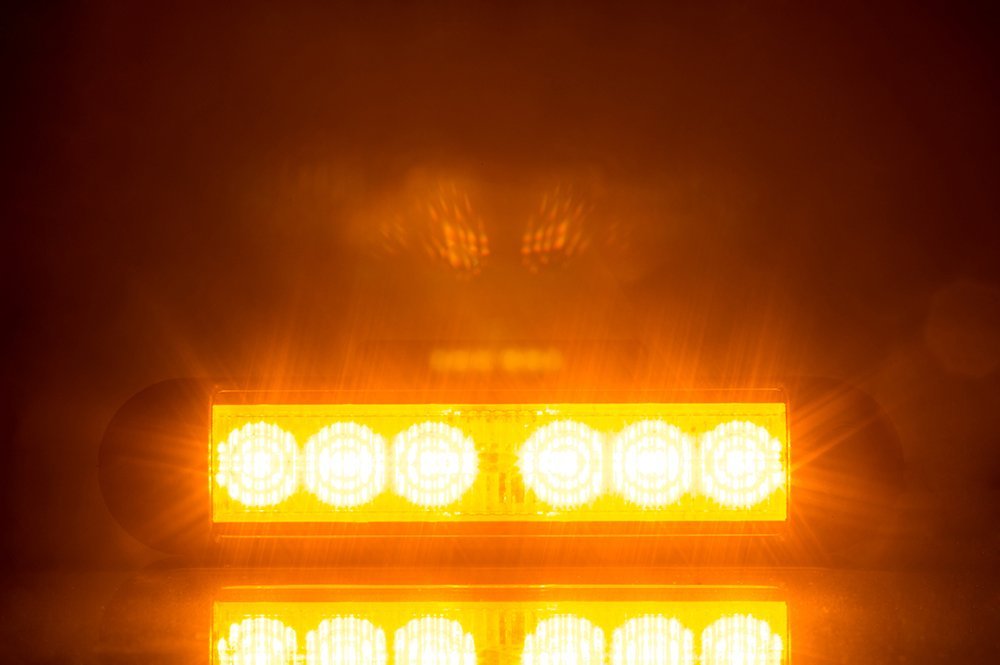Amber LED Flashing Warning Light LDO 2780 showing bright amber light with six LEDs illuminated in dark environment.