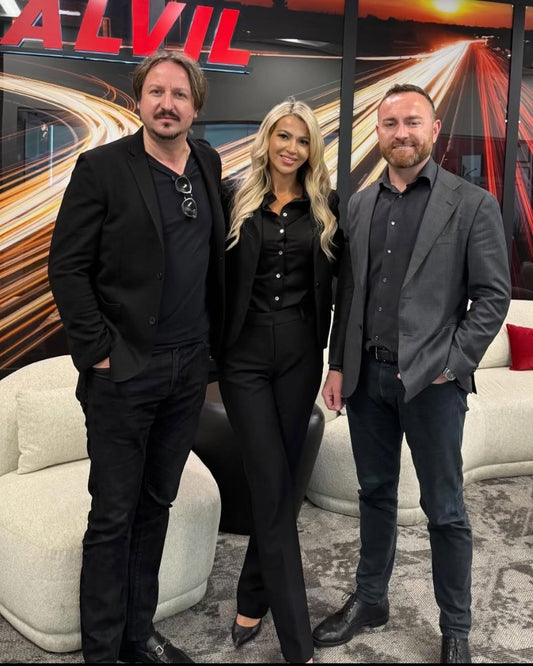 RoadLites founders Angie Twardawa and Rafael Twardawa standing next to Alvil Trucking Owner Denys Paniv infront of Alvil Sign