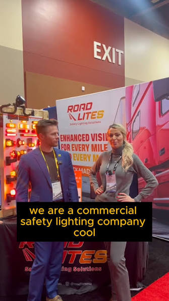 RoadLites Co-Founder Angie Twardawa with Truck Parking Club CEO Evan Shelley at the RoadLites booth during a trucking industry conference