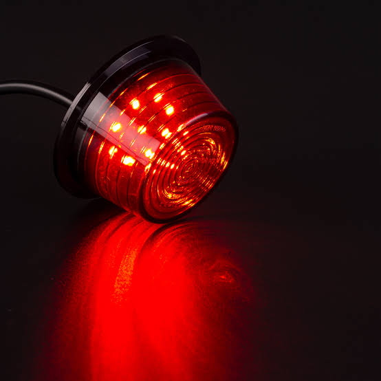 Red stalk trailer marker light glowing in the dark