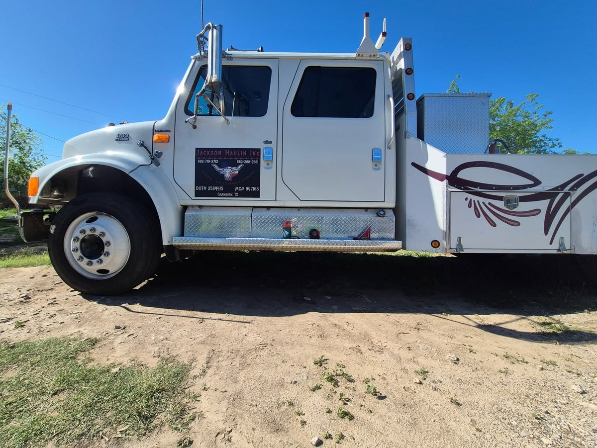 White Tow Truck getting RoadLites amber marker lights installed.