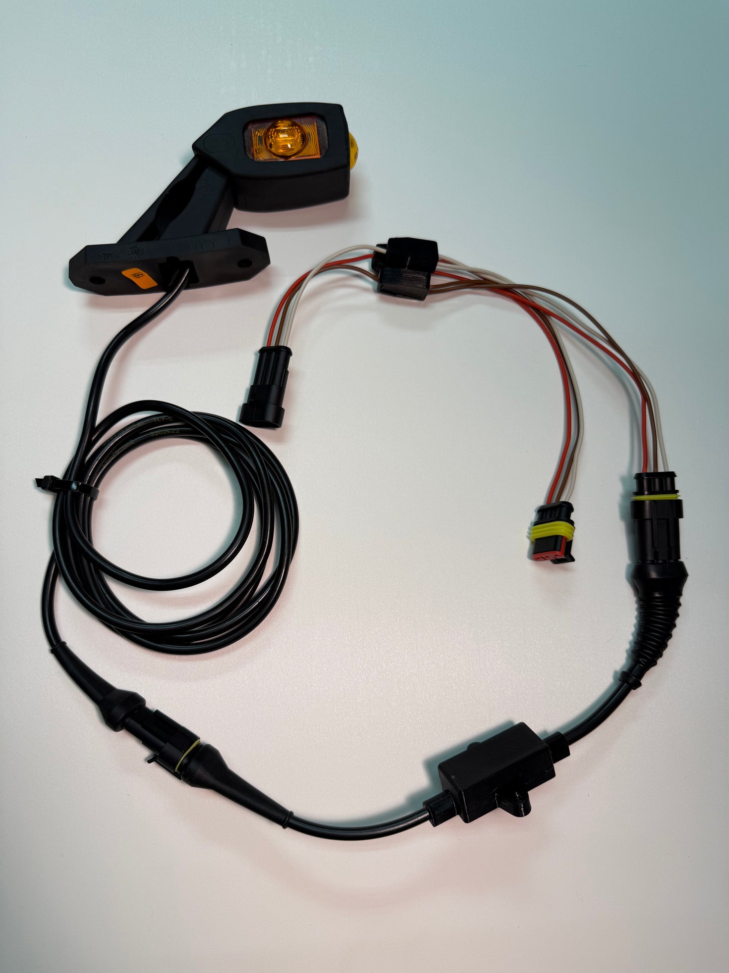 Triple Auxiliary LED Outline Marker Light Set LD 2109 with amber LED, wiring harness, and mounting arm for vehicles.