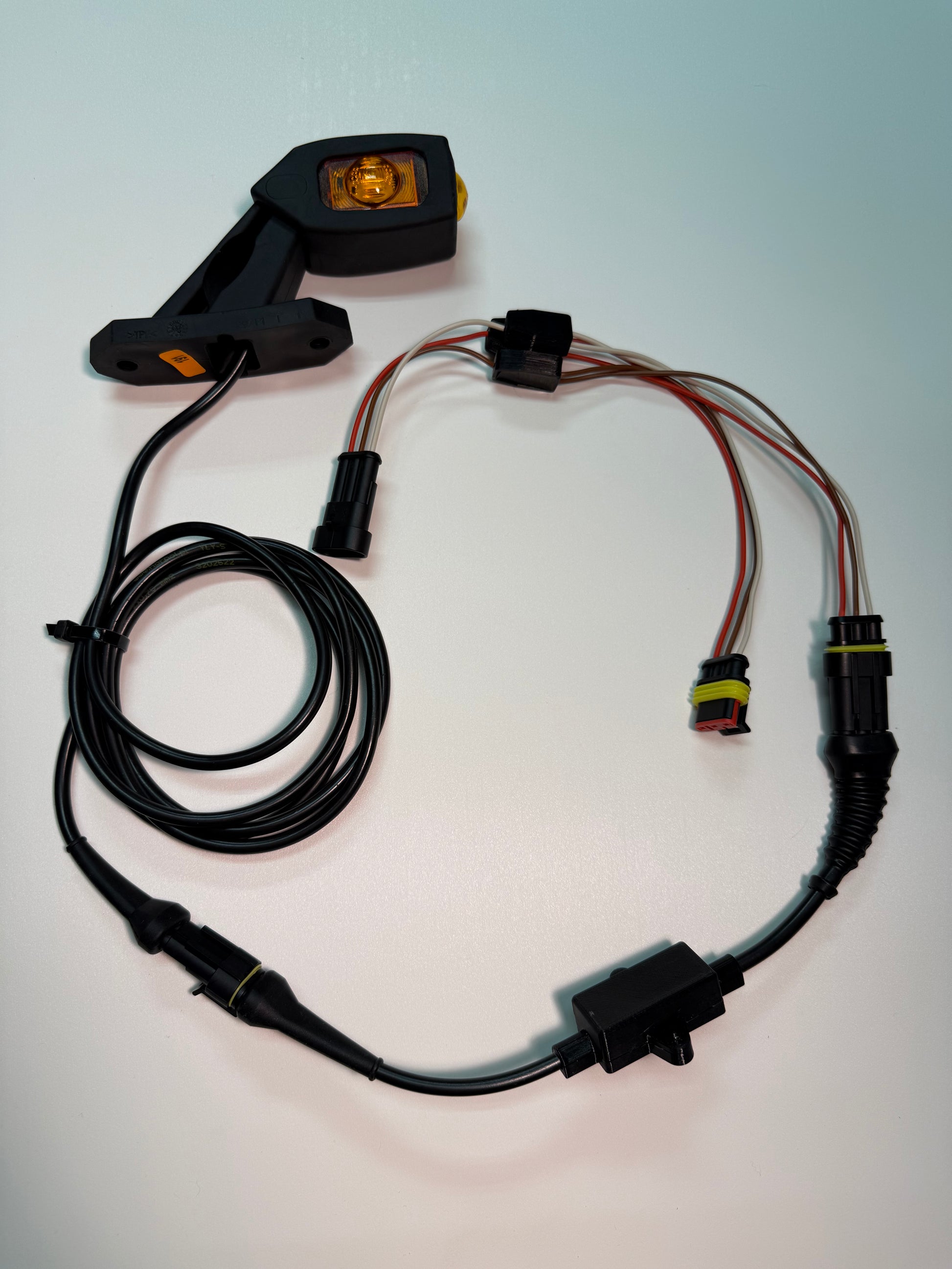 Triple Auxiliary LED Outline Marker Light Set LD 2109 with amber LED, wiring harness, and mounting arm for vehicles.