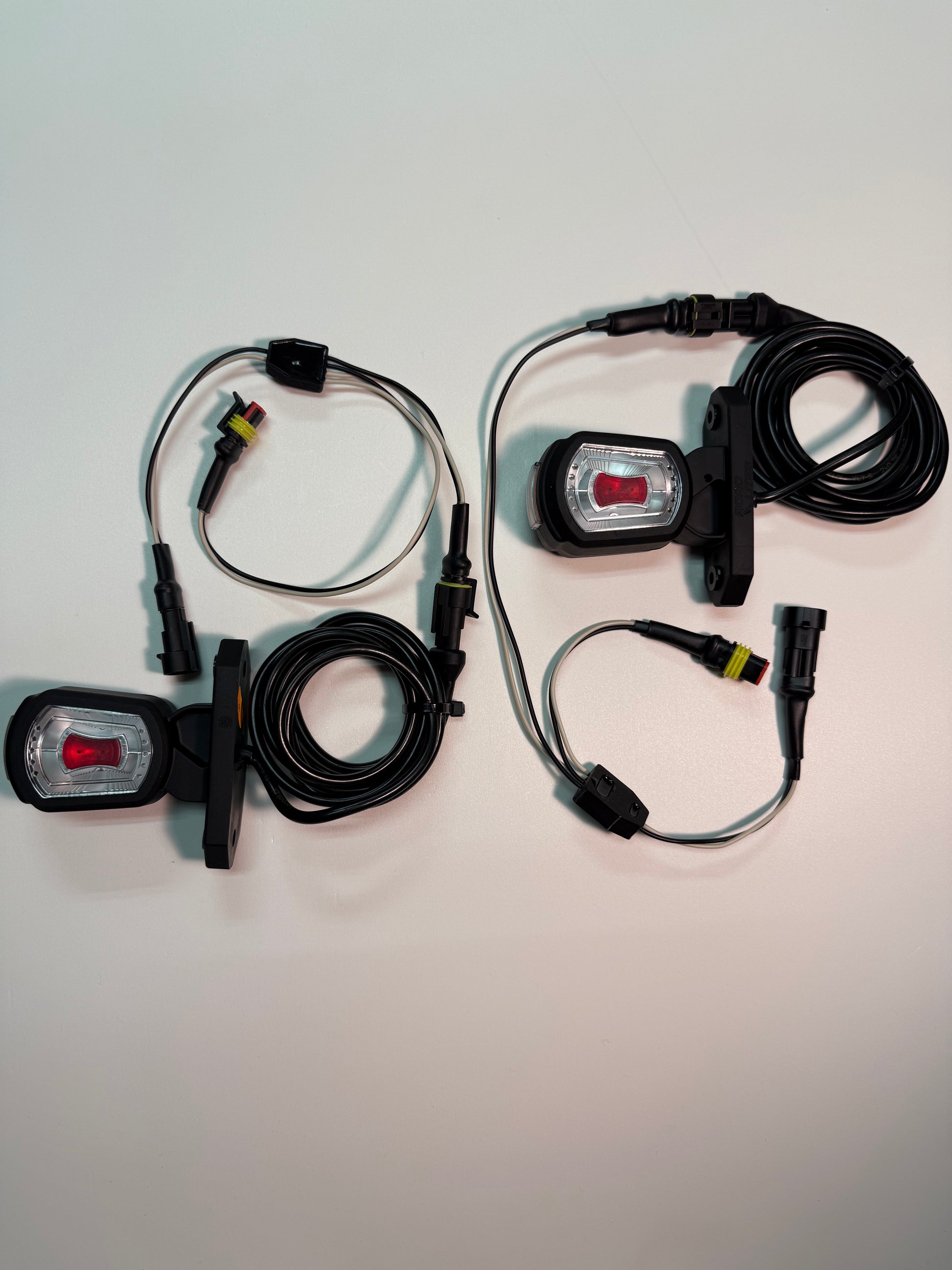 Short Arm LED Side Outline Marker Lamp Set LDCC 2776 & LDCC 2777 with superseal wiring and connectors on white surface.