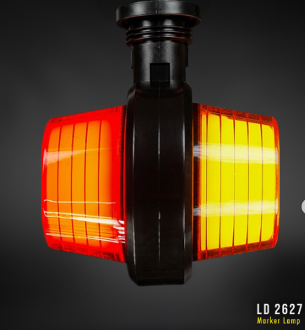 Amber Red Outline marker light with a black plastic housing and two translucent amber-red lenses, shown against a dark gray gradient background. White text in the bottom right corner reads 'LD 2627 Marker Lamp'.