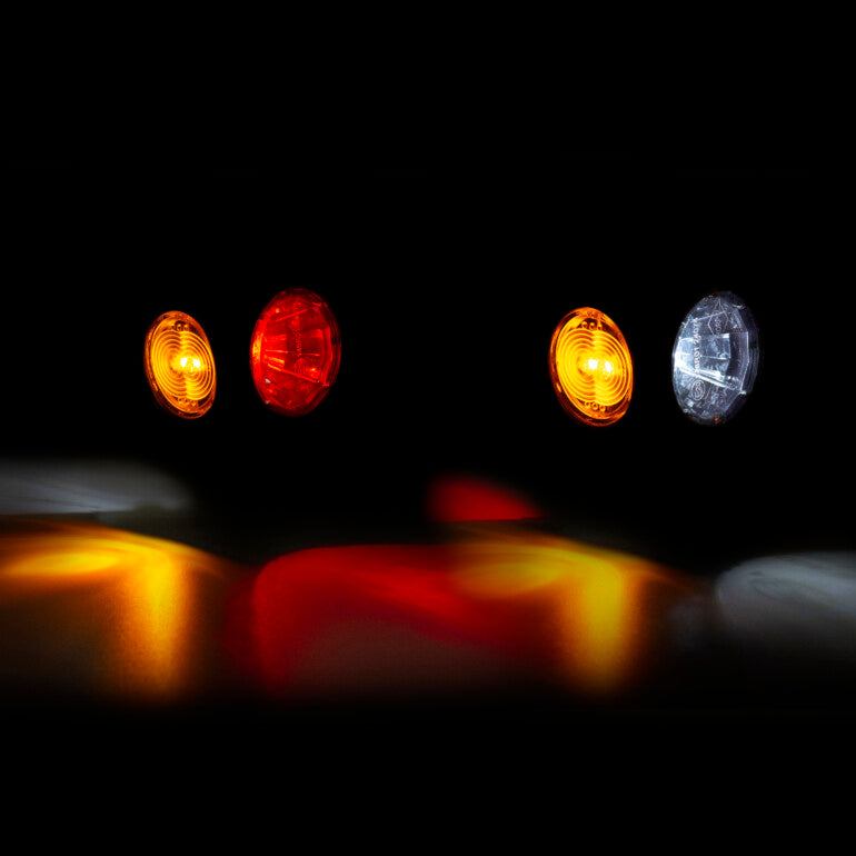 Four outline arm marker lights in different colors on a black background