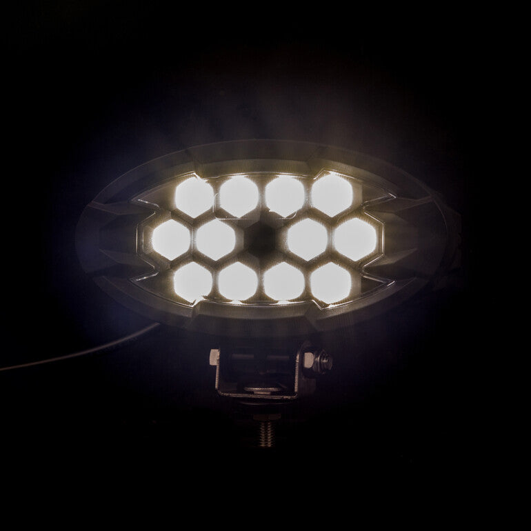Work light RAPTOR (dispersed light, 2500 lm) LRD 3161 bright white LEDs arranged in hexagonal cluster glowing in dark background