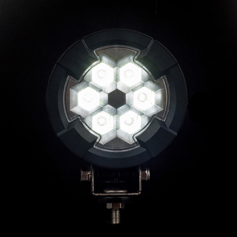Work light RAPTOR (dispersed light, 2600 lm) LRD 3180 illuminated hexagonal LED cluster with black mounting bracket visible