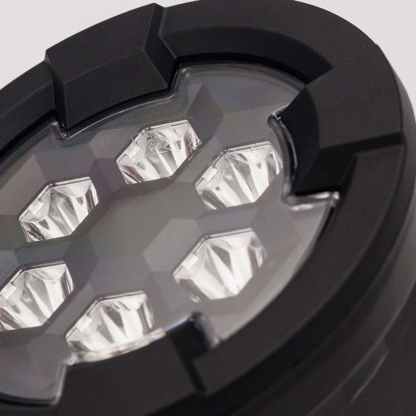 Close-up of six LED lenses inside black housing of Work light RAPTOR (focused light, 1600 lm) LRD 3187