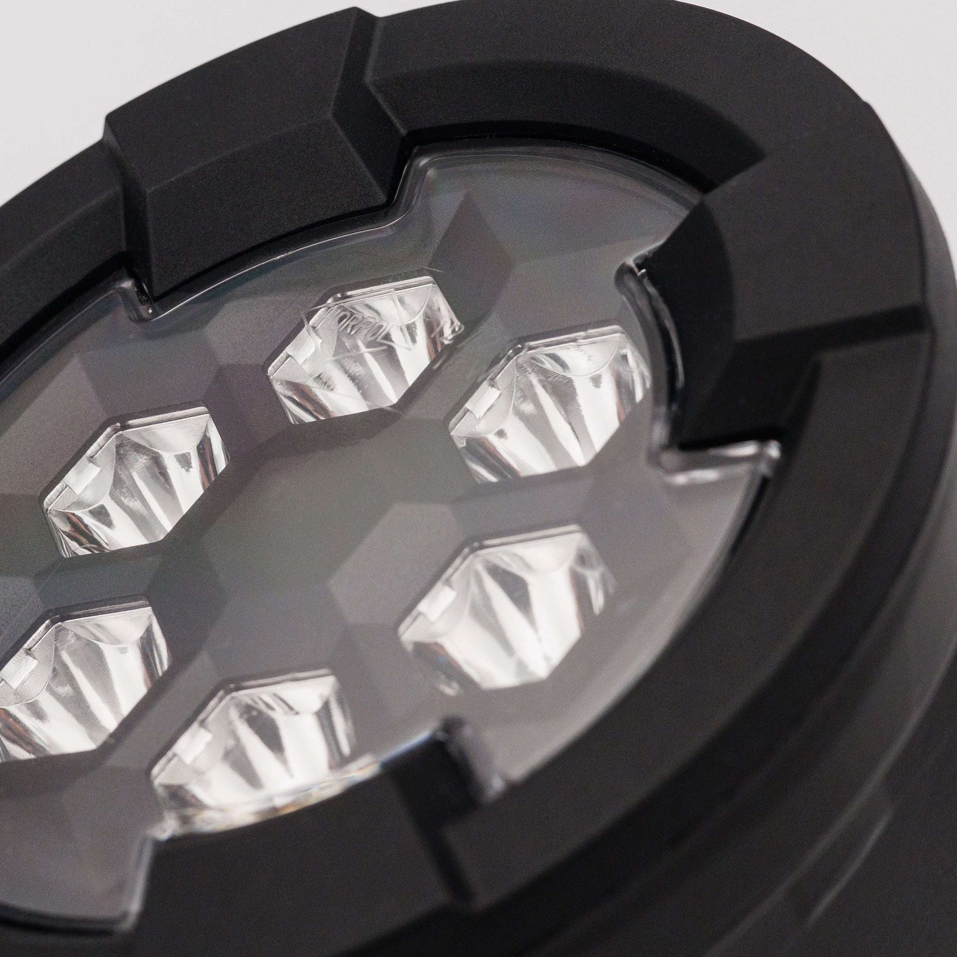 Close-up of six LED lenses inside black housing of Work light RAPTOR (focused light, 1600 lm) LRD 3187