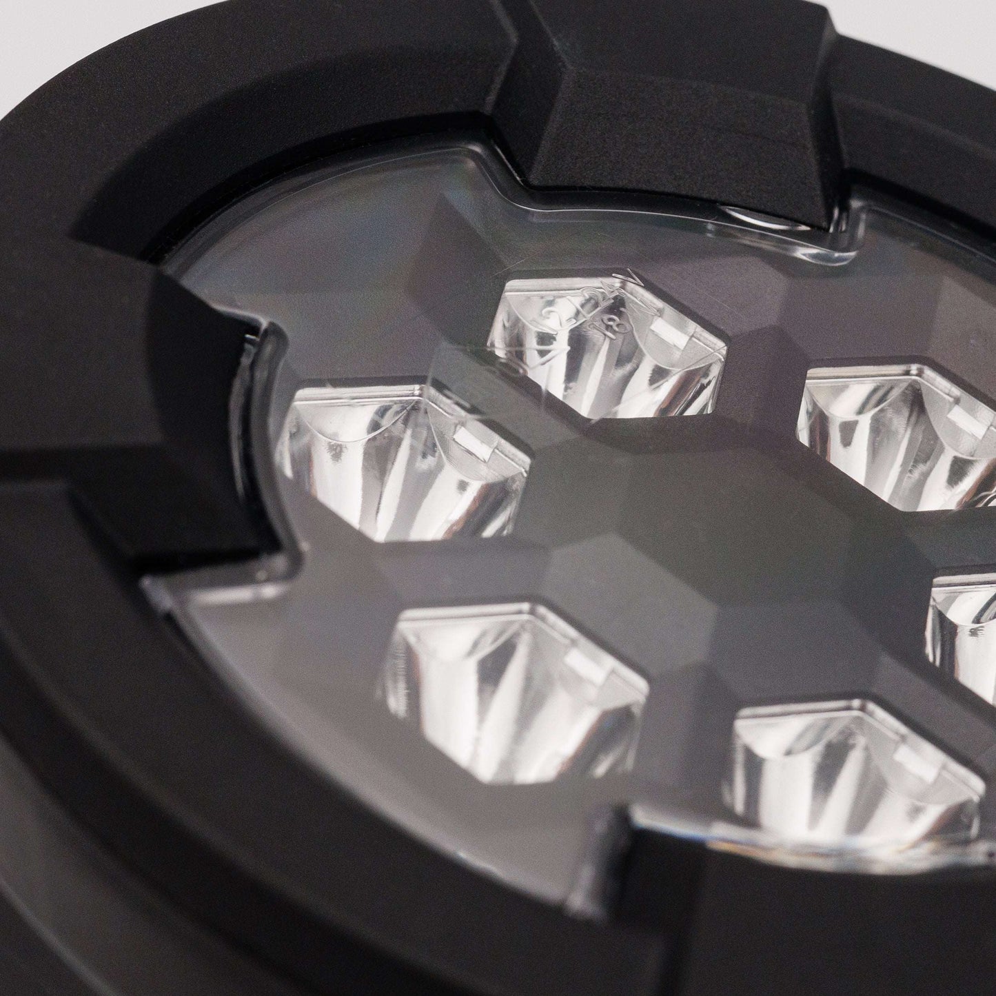 Close-up view of six reflective LED lenses within black casing of Work light RAPTOR (focused light, 1600 lm) LRD 3187