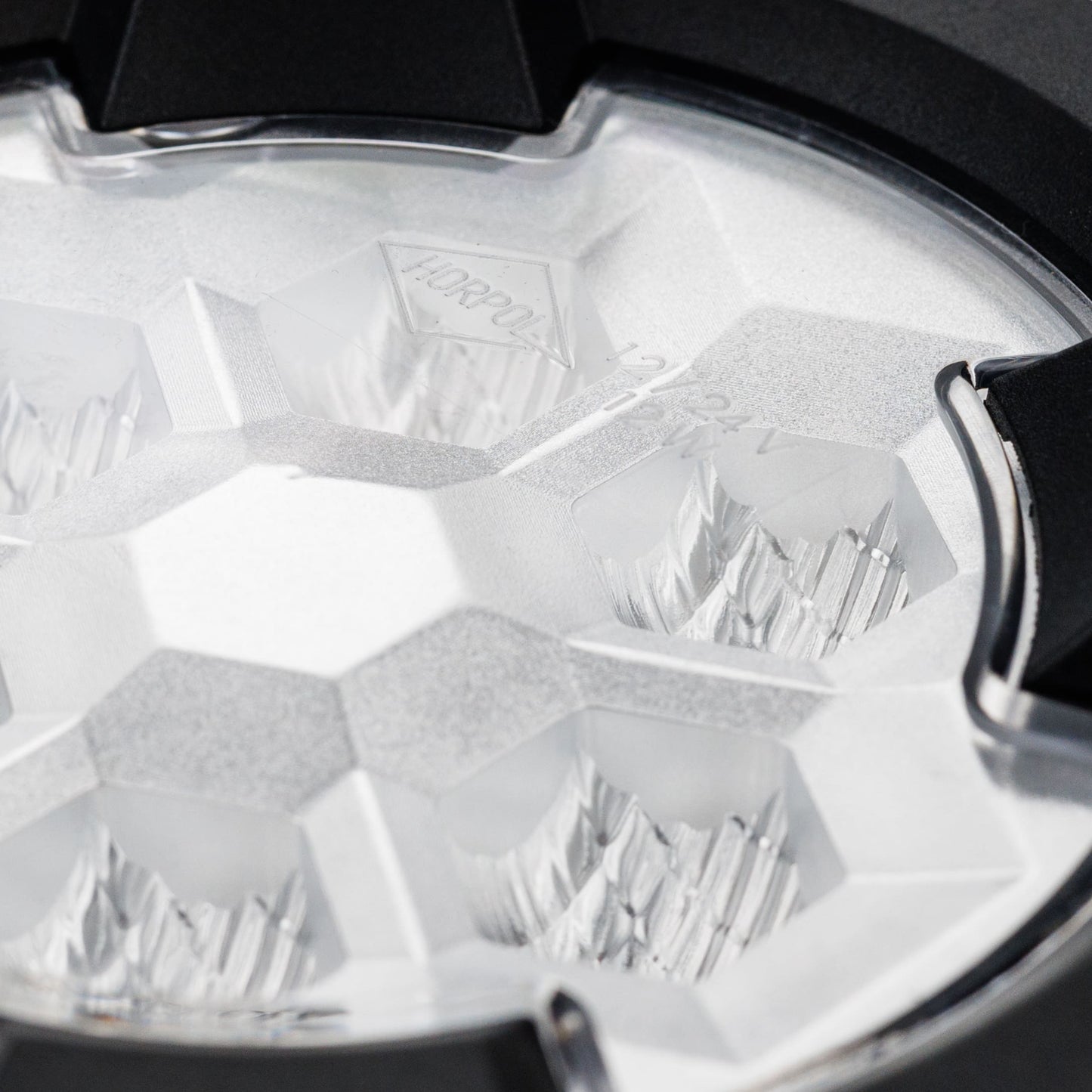 Work light RAPTOR (dispersed light, 650 lm) LRD 3188 close-up of clear lens with multifaceted reflector and mounting clip detail
