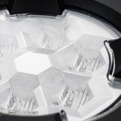 Work light RAPTOR (dispersed light, 650 lm) LRD 3188 close-up of clear lens with multifaceted reflector and mounting clip detail