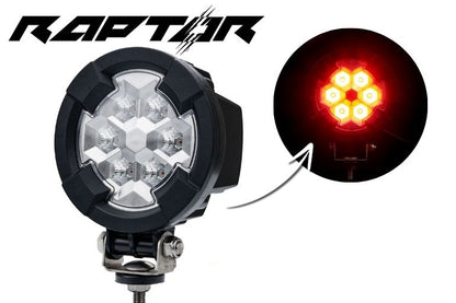 Work light RAPTOR (dispersed light, 650 lm) LRD 3188 showing seven amber LED clusters glowing bright on black housing with mounting bracket